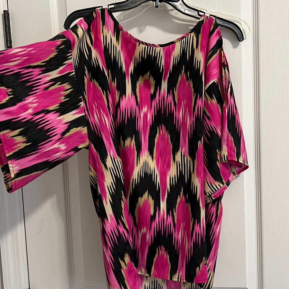 Cute women’s summer top; never worn , cut out on arms.